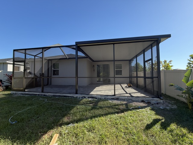 Screen enclosure over patio